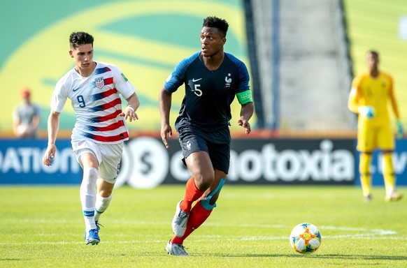 epa07625956 Dan Zagadou (R) of France in action against Sebastian Soto (L) of USA during the FIFA Under-20 World Cup 2019, Round of 16 soccer match between France and USA at the Zdzislaw Krzyszkowiak  ...