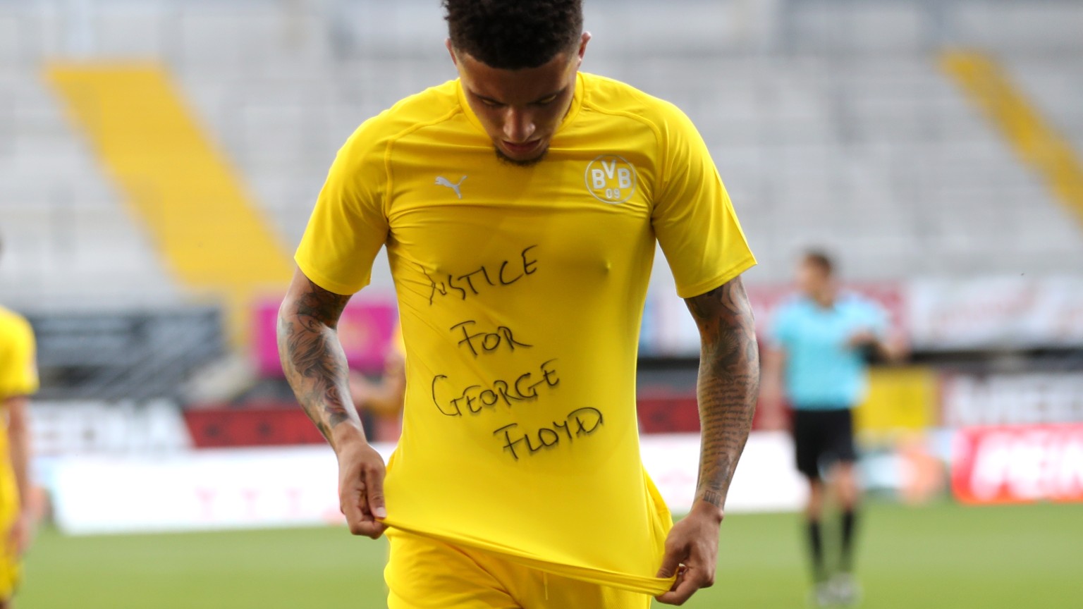 epa08456508 Jadon Sancho of Borussia Dortmund celebrates scoring the 0-2 goal with a &#039;Justice for George Floyd&#039; shirt during the German Bundesliga soccer match between SC Paderborn 07 and Bo ...