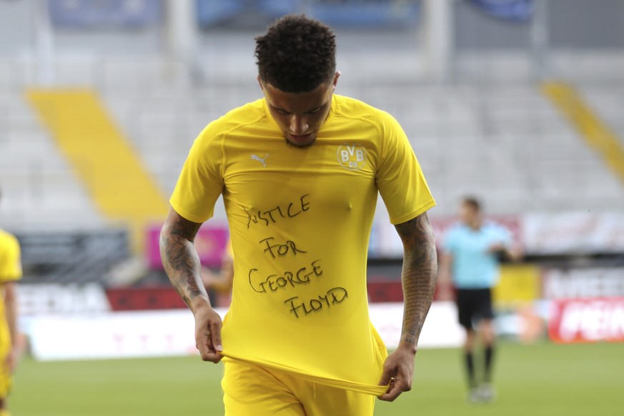 Jadon Sancho of Borussia Dortmund celebrates scoring his teams second goal of the game with a &#039;Justice for George Floyd&#039; shirt during the German Bundesliga soccer match between SC Paderborn  ...