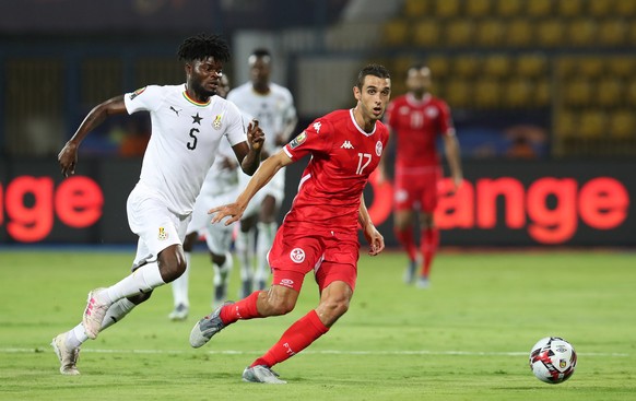 epa07704231 Ellyes Joris Skhiri of Tunisia challenged by Thomas Teye Partey of Ghana during the 2019 Africa Cup of Nations Last 16 match between Ghana and Tunisia at the Ismailia Stadium, Ismailia, Eg ...