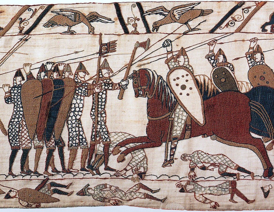 Schildwall der Angelsachsen bei der Schlacht bei Hastings, Detail aus dem Teppich von Bayeux. 
https://en.wikipedia.org/wiki/Battle_of_Hastings#/media/File:Bayeuxtapestryscene52.jpg