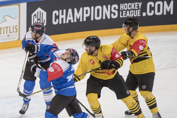 Dominic Lammer, left, from Zug and Philippe Lakos, centre, from Vienna, during the Champions Hockey League group C match between Switzerland&#039;s EV Zug and Vienna Capitals from Austria, in Zug, Swi ...