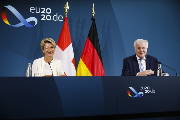 German Interior Minister Horst Seehofer, right, and Switzerland&#039;s Justice Minister Karin Keller-Sutter brief the media after a meeting at the Interior Ministry in Berlin, Germany, Tuesday, July 2 ...