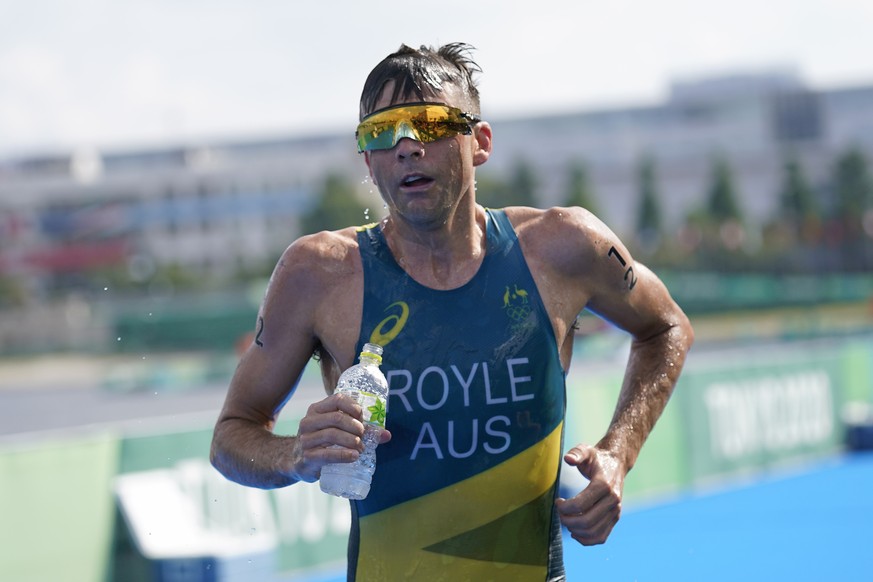 Aaron Royle of Australia takes water as he competes in the run portion of the men&#039;s individual triathlon at the 2020 Summer Olympics, Monday, July 26, 2021, in Tokyo, Japan. (AP Photo/Jae C. Hong ...