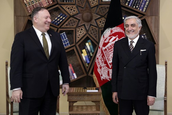 U.S. Secretary of State Mike Pompeo, left, stands with Abdullah Abdullah the main political rival of President Ashraf Ghani at the Sepidar Palace, in Kabul, Afghanistan, Monday, March 23, 2020. Pompeo ...