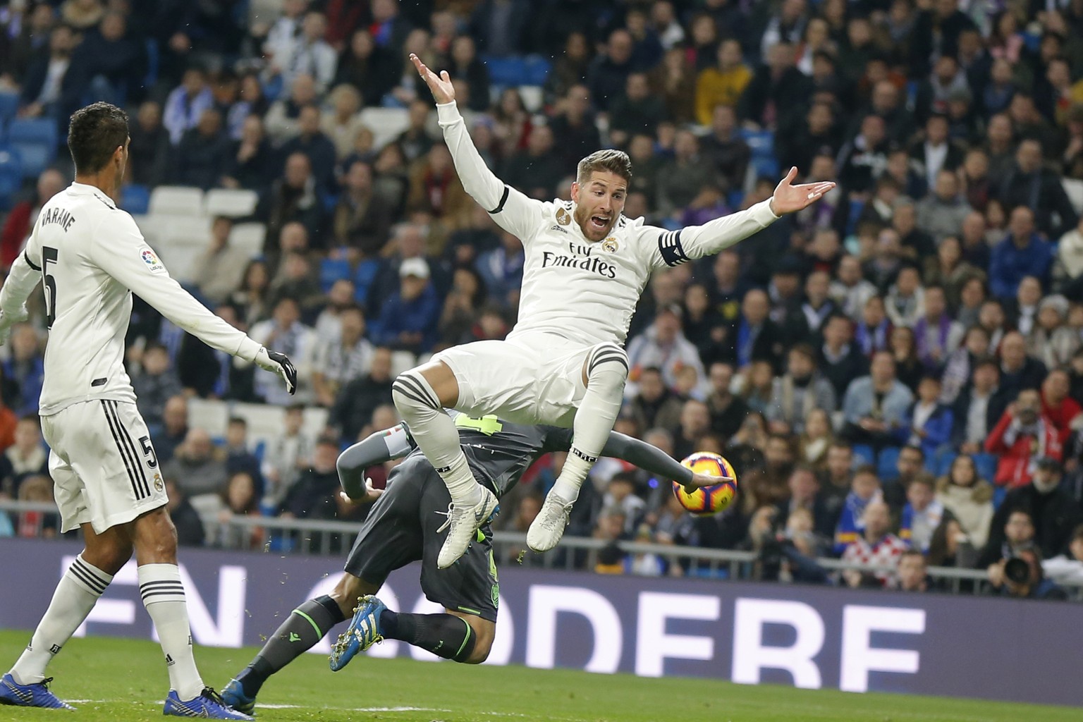 Real Madrid&#039;s Sergio Ramos jumps, with Real Sociedad&#039;s Asier Illarramendi, obscured behind, during a Spanish La Liga soccer match between Real Madrid and Real Sociedad at the Santiago Bernab ...