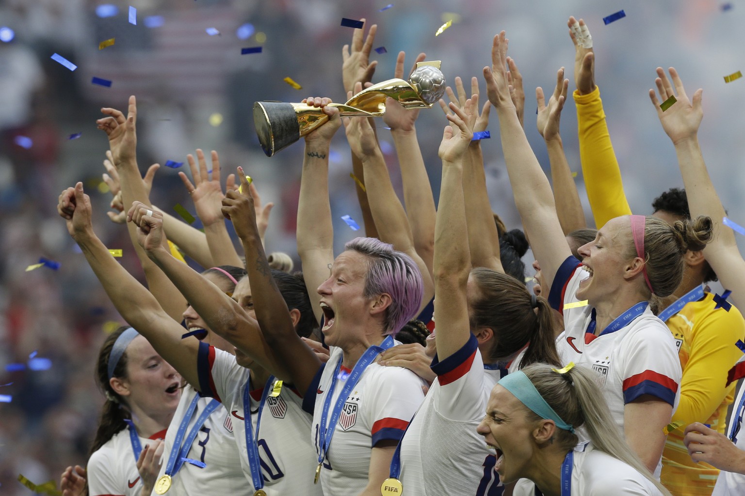 FILE - In this July 7, 2019, file photo, U.S. player Megan Rapinoe holds the trophy after winning the Women&#039;s World Cup final soccer match against The Netherlands at the Stade de Lyon in Decines, ...