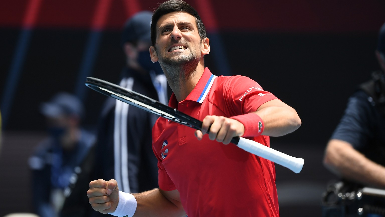 epaselect epa08980716 Novak Djokovic of Serbia reacts after winning an ATP Cup tennis match against Denis Shapovalov of Canada at Melbourne Park in Melbourne, Australia, 02 February 2021. EPA/DAVE HUN ...