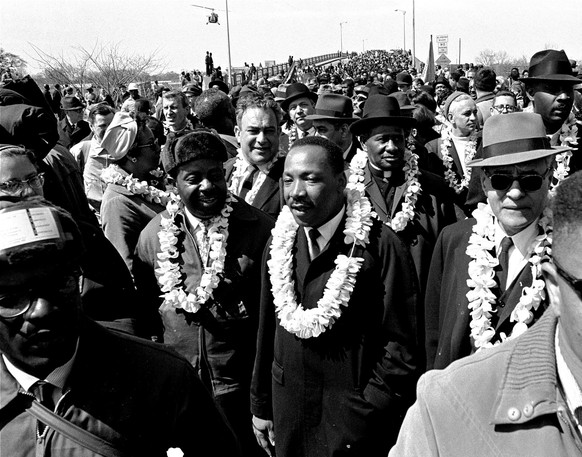 FILE - In this March 21, 1965 file photo, Martin Luther King, Jr. and his civil rights marchers cross the Edmund Pettus Bridge in Selma, Ala., heading for the capitol, Montgomery, during a five day, 5 ...