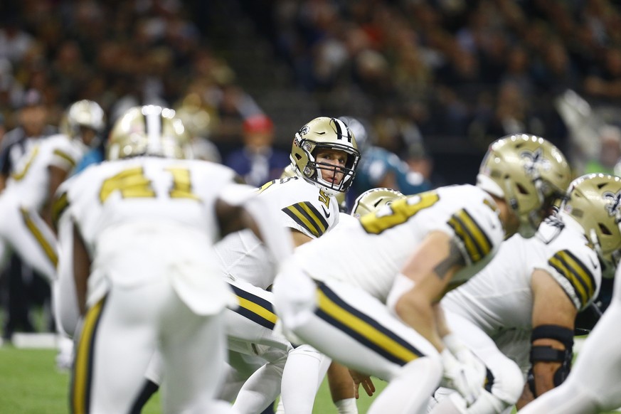 New Orleans Saints quarterback Drew Brees (9) crouches under center in the first half of an NFL football game against the Philadelphia Eagles in New Orleans, Sunday, Nov. 18, 2018. (AP Photo/Butch Dil ...