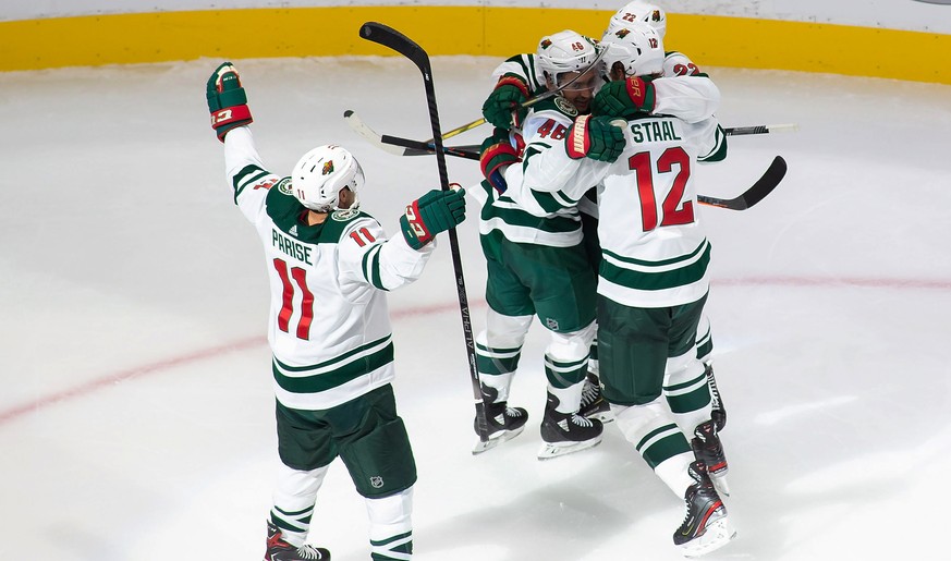 Minnesota Wild&#039;s Zach Parise (11), Jared Spurgeon (46), Kevin Fiala (22) and Eric Staal (12) celebrate a goal by Spurgeon against the Vancouver Canucks during the second period of an NHL hockey p ...
