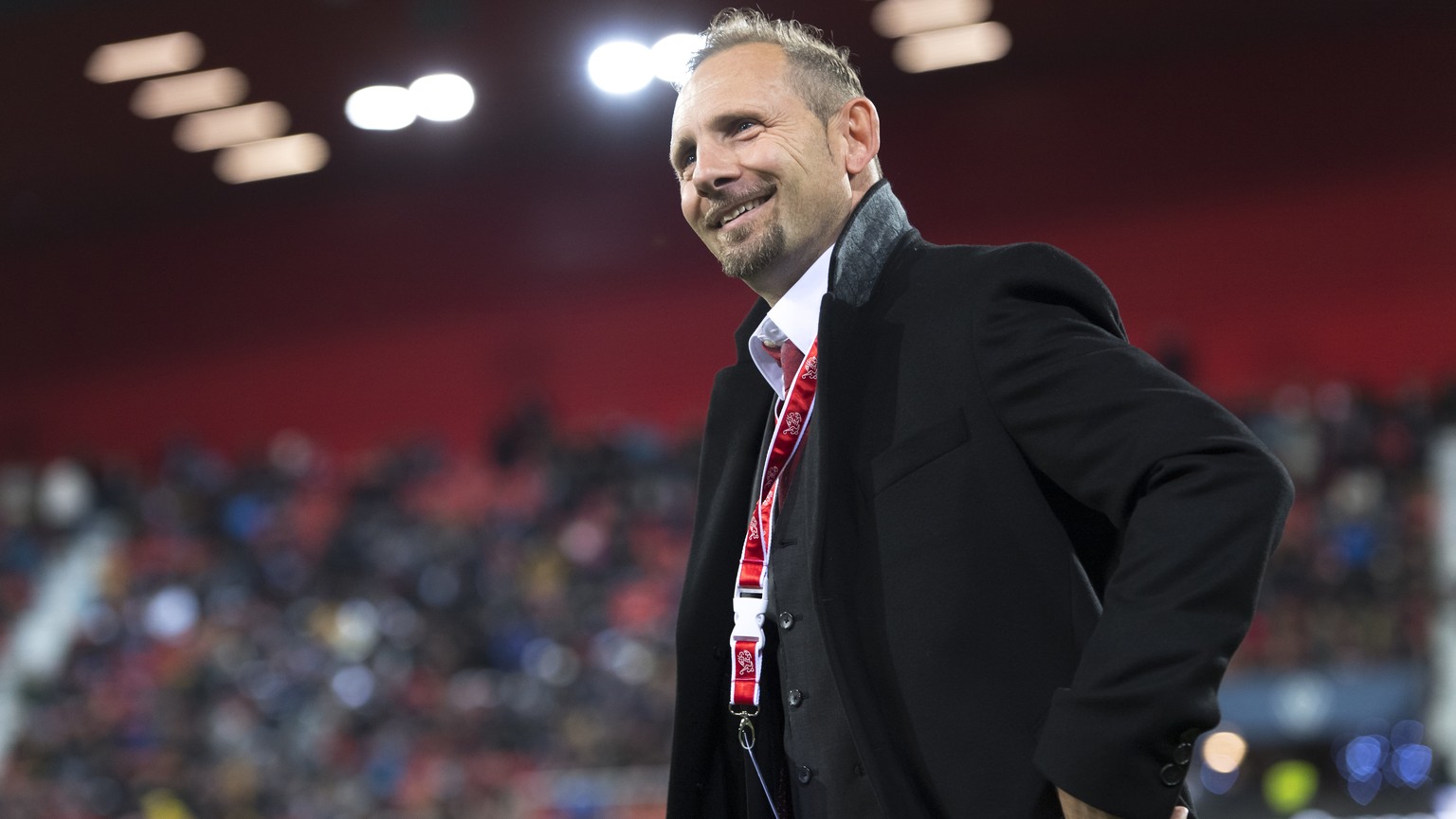 Switzerland&#039;s head coach Mauro Lustrinelli smiles before a qualification soccer match for the European Under 21 Championship between Switzerland and France at the Stadium Stade de la Maladiere, i ...