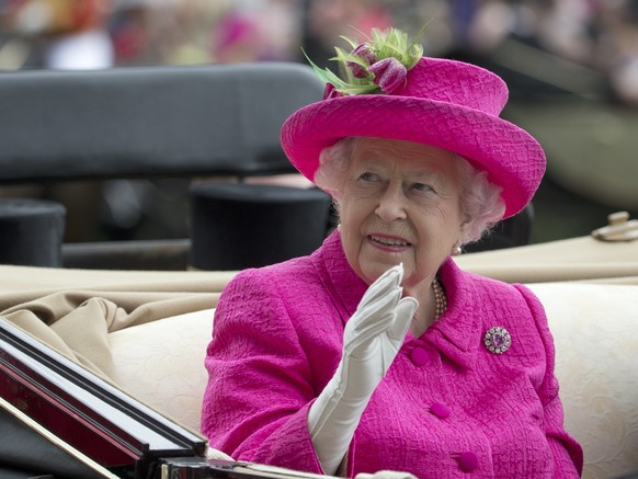 FILE- In this Thursday, June 22, 2017 file photo, Britain&#039;s Queen Elizabeth II waves to the crowd as she arrives by open carriage into the parade ring on the third day of the Royal Ascot horse ra ...