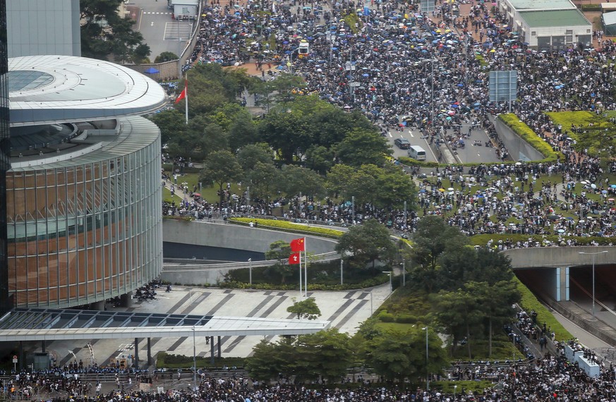 Thousands of protesters block access to the Legislative Council in Hong Kong, Wednesday, June 12, 2019. One year ago, a sea of humanity _ a million people by some estimates _ marched through central H ...