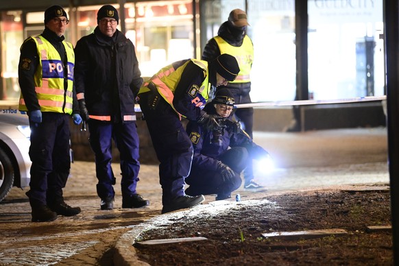 epa09049639 Police technicians on the scene of an attack in central Vetlanda, Sweden, 03 March 2021. Eight people have reportedly been left injured in an attack in southern Sweden described by police  ...