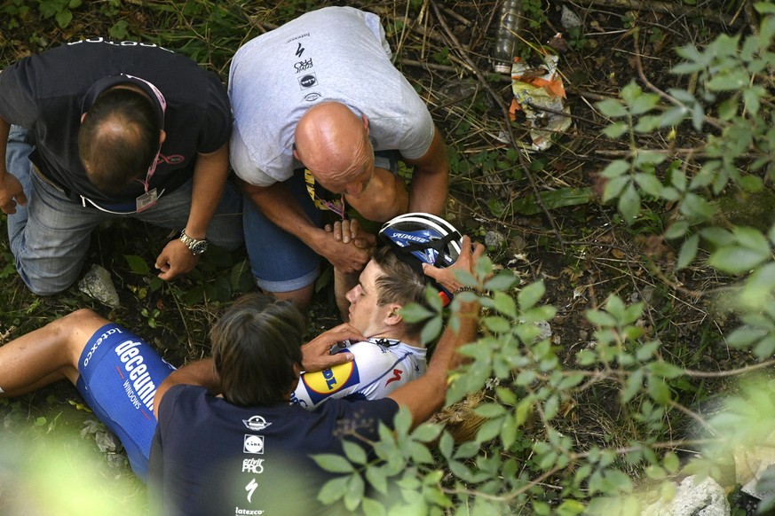 Cyclist Remco Evenepoel receives first aid after falling during the Tour of Lombardy cycling race, from Bergamo to Como, Italy, Saturday, Aug. 15, 2020. (Fabio Ferrari/LaPresse via AP)