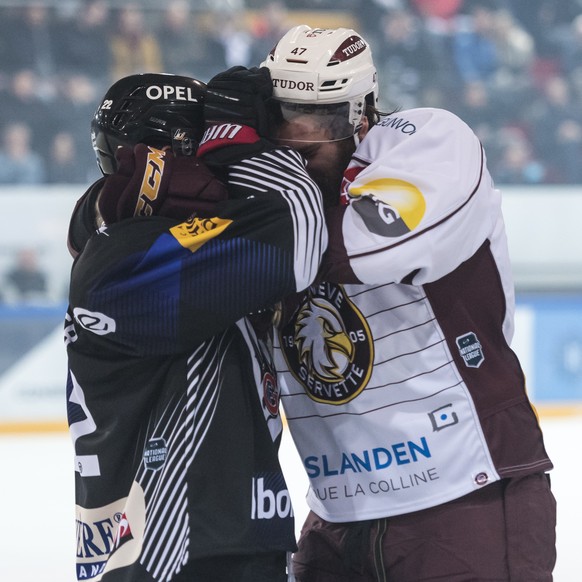 L&#039;attaquant fribourgeois Jim Slater, gauche, se bat avec le defenseur genevois Eliot Antonietti, droite, lors de la rencontre du championnat suisse de hockey sur glace de National League entre le ...
