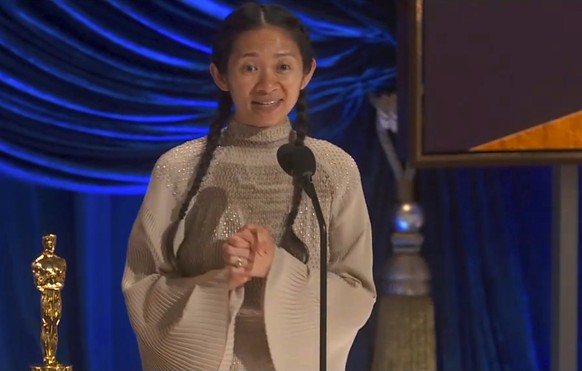 In this video image provided by ABC, Chloe Zhao accepts the award for best director for &quot;Nomadland&quot; at the Oscars on Sunday, April 25, 2021. (ABC via AP)