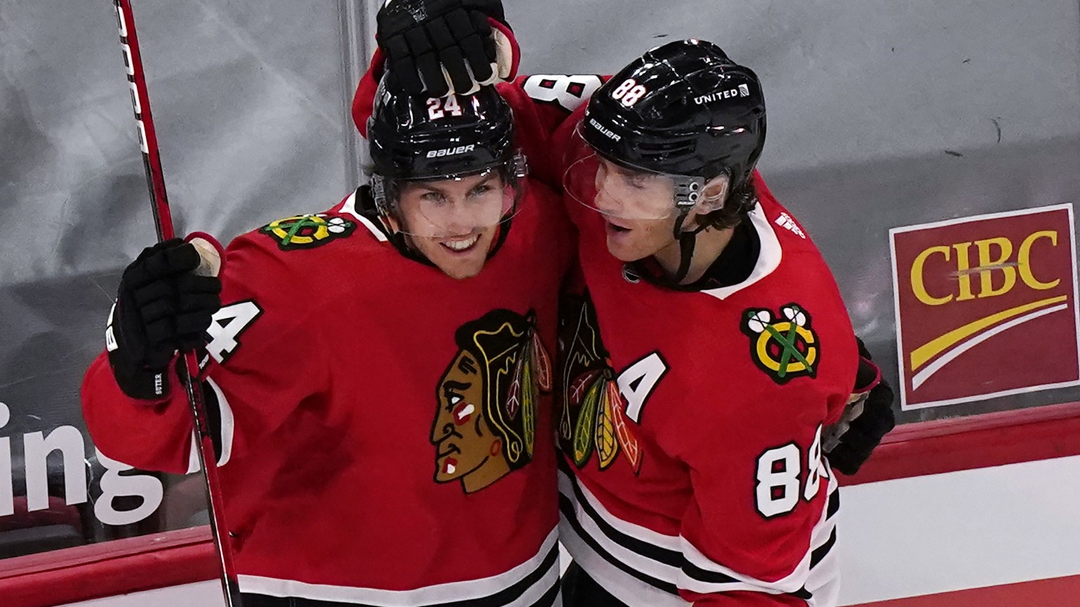Chicago Blackhawks center Pius Suter, top left, celebrates with right wing Patrick Kane after scoring a goal as Detroit Red Wings goalie Jonathan Bernier reacts during the first period of an NHL hocke ...
