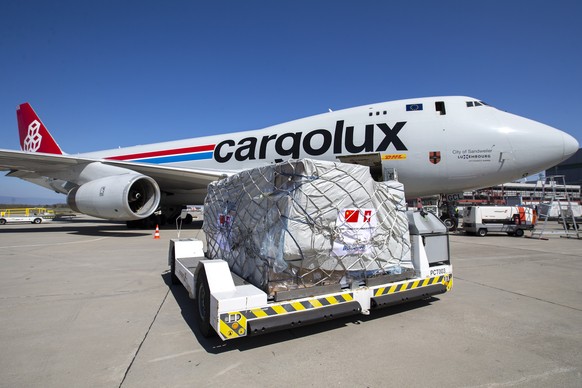epa08346075 Medical supplies from China are unloaded from a Boeing 747-400F (LX-GCL) cargo aircraft at the Geneve Aeroport, in Geneva, Switzerland, 06 April 2020. An aircraft of Cargolux carrier from  ...
