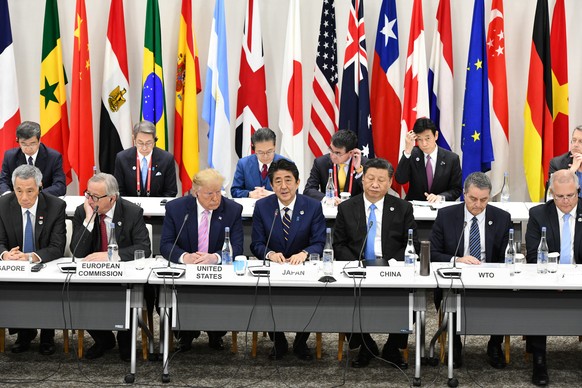 epa07679067 A handout image made available by the G20 organizing host shows Leaders of the G20 Summit during the Digital Economy event on the sidelines of the G20 summit in Osaka, Japan, 28 June 2019. ...