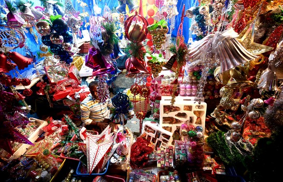 epa07242581 People buy decorative items for the upcoming Christmas holidays, in Bangalore, India, 20 December 2018. People hang Christmas stars in front of the house entrance for prosperity to enter t ...