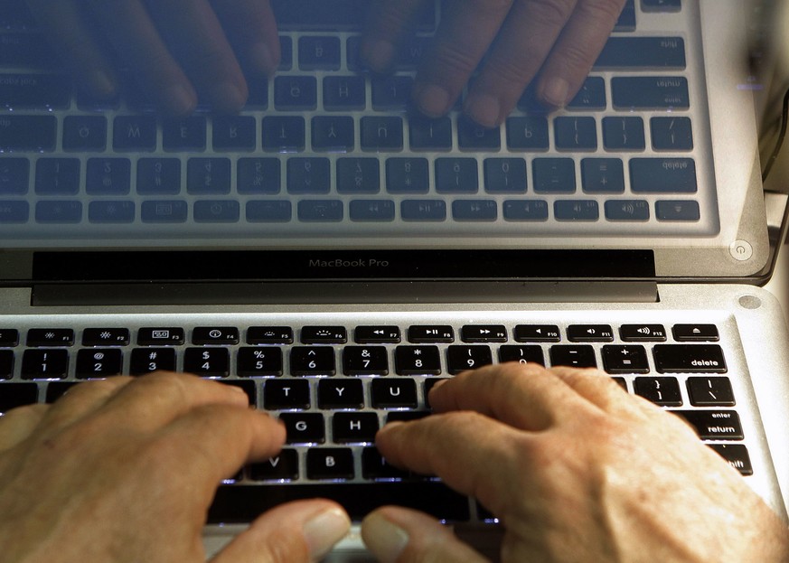 FILE - In this Feb. 27, 2013, file photo, hands type on a computer keyboard in Los Angeles. Hackers have gained access to OneLogin, an online password manager that offers a single sign-on to multiple  ...
