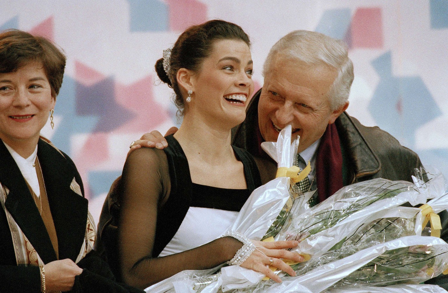 American figure skater Nancy Kerrigan gets congratulated by her coach Evy Scotvold following her performance in the women&#039;s technical program at Hamar, Norway, Feb. 23, 1994. Kerrigan sits in fir ...
