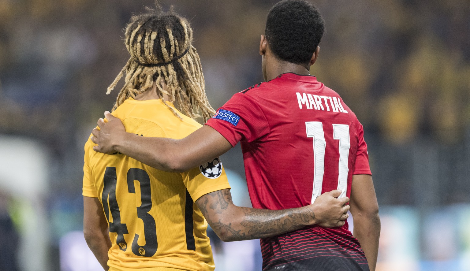YB&#039;s Kevin Mbabu, left, hugs Manchester United&#039;s Anthony Martial, right, after the UEFA Champions League group H matchday 1 soccer match between Switzerland&#039;s BSC Young Boys and England ...