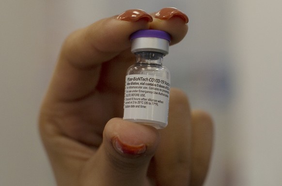 A medical professional holds a vial of the coronavirus vaccine at a health center in Jerusalem, Wednesday, Dec. 30, 2020. (AP Photo/Maya Alleruzzo)