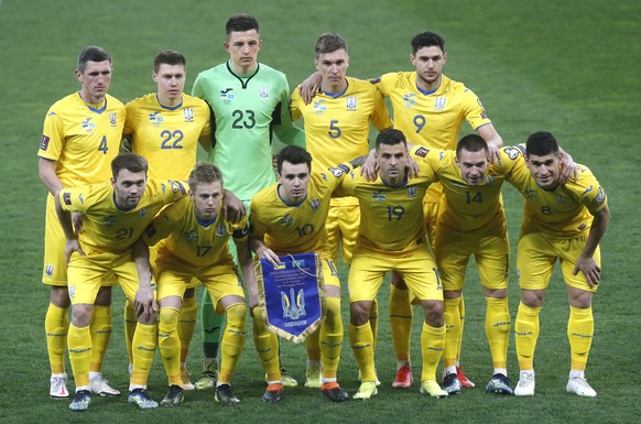 Ukraine starting players pose for a team photo at the beginning of the World Cup 2022 group D qualifying soccer match between Ukraine and Kazakhstan at the Olimpiyskiy Stadium in Kyiv, Ukraine, Wednes ...