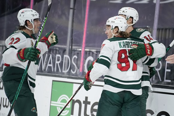 Minnesota Wild&#039;s Kevin Fiala (22) celebrates after Kirill Kaprizov (97) scored against the Vegas Golden Knights during the third period of an NHL hockey game Saturday, April 3, 2021, in Las Vegas ...