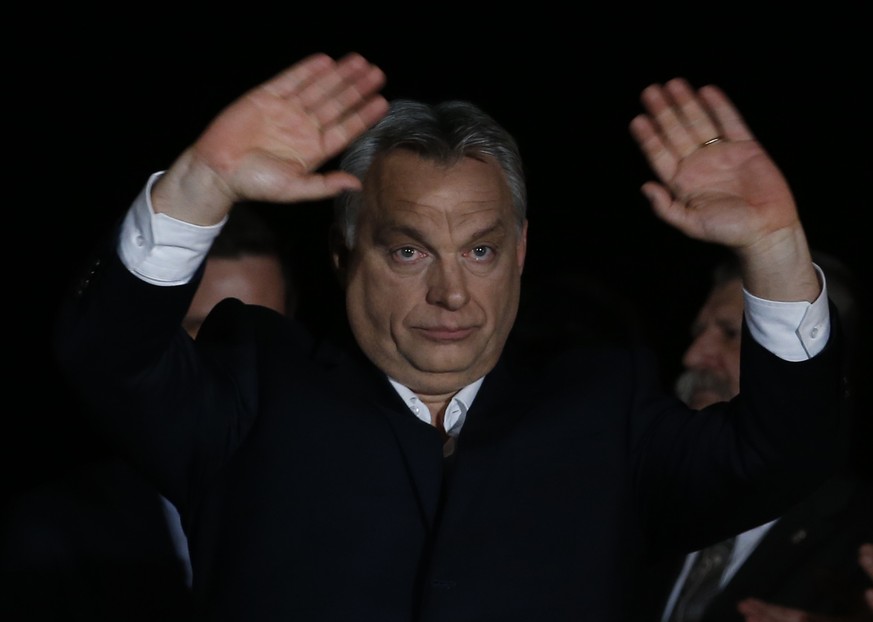 Hungarian Prime Minister Viktor Orban greets his supporters in Budapest, Hungary, Sunday, April 8, 2018. Preliminary results show populist Hungarian Prime Minister Viktor Orban has easily won a third  ...