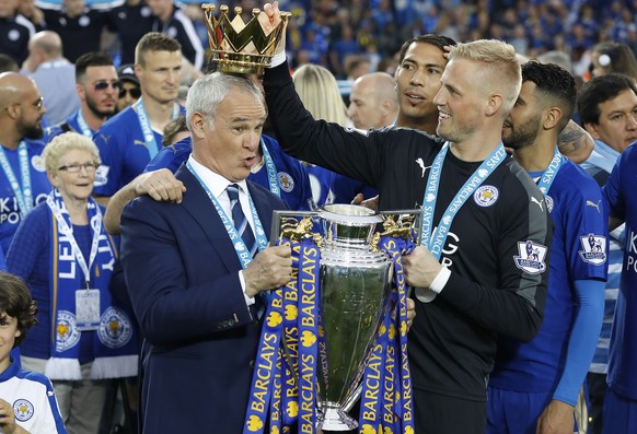Leicesters team manager Claudio Ranieri gets a crown by Leicesters goalkeeper Kasper Schmeichel as they lift the trophy as Leicester City celebrate becoming the English Premier League soccer champio ...
