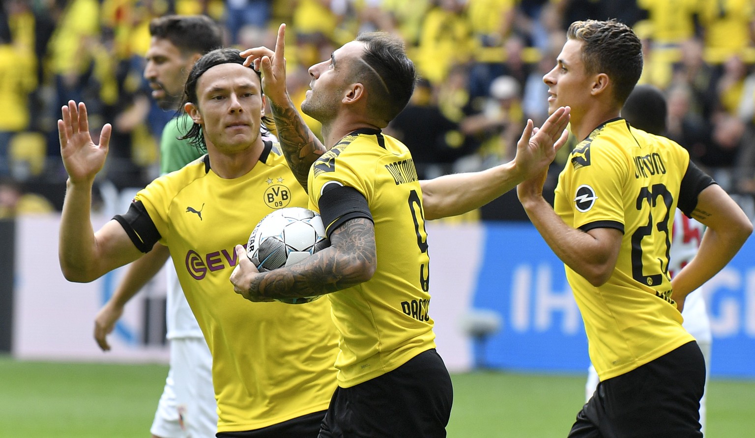 Dortmund&#039;s Paco Alcacer, center, celebrates after scoring his side&#039;s first goal during the German Bundesliga soccer match between Borussia Dortmund and FC Augsburg at the Signal Iduna Park s ...