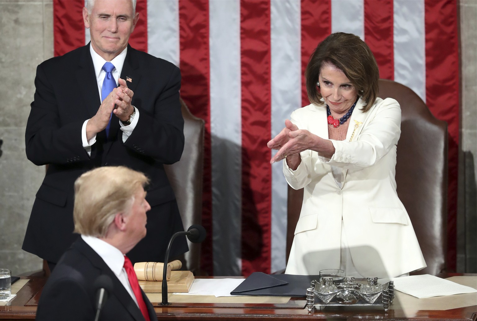 President Donald Trump turns to House speaker Nancy Pelosi of Calif., as he delivers his State of the Union address to a joint session of Congress on Capitol Hill in Washington, as Vice President Mike ...