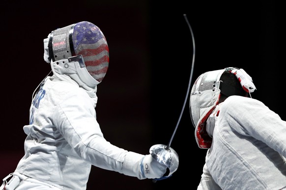 epa09360989 Daryl Homer (L) of the USA in action against Mohamed Amer of Egypr in the men&#039;s Sabre individual round of 32 during the Fencing events of the Tokyo 2020 Olympic Games at the Makuhari  ...