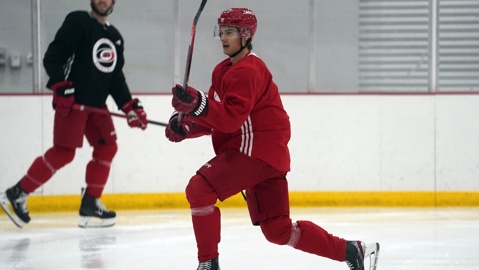 Carolina Hurricanes&#039; Sebastian Aho, of Finland, follows through with a shot during NHL hockey training camp in Morrisville, N.C., Wednesday, Jan. 6, 2021. (AP Photo/Gerry Broome)
