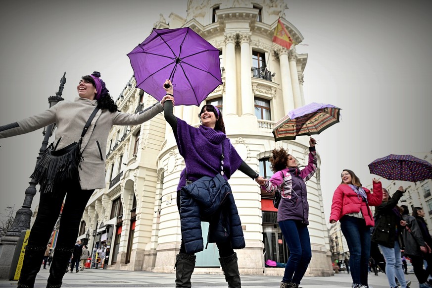 epa08202494 Women take part in a feminist chain surrounding the center of the city to mark the start of preparations for the March 8th feminists protest, in Madrid, Spain, 08 February 2020. One month  ...