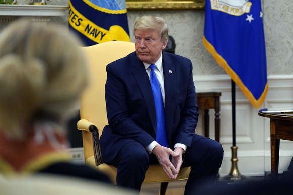 President Donald Trump listens during a meeting with Gov. Kim Reynolds, R-Iowa, in the Oval Office of the White House, Wednesday, May 6, 2020, in Washington. (AP Photo/Evan Vucci)
Donald Trump,Kim Rey ...
