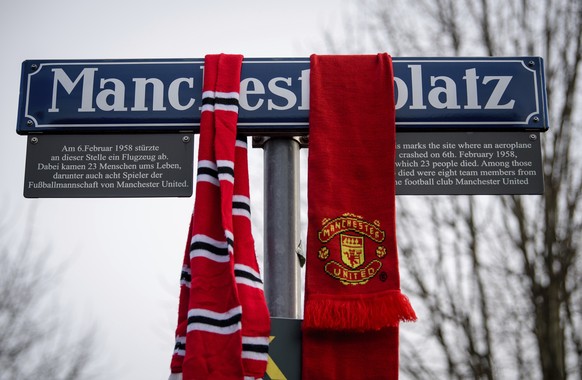 Scarfs of soccer fans hang on the Manchesterplatz street sign during a commemoration ceremony on the Manchester place at the Munich Riem airport, southern Germany, Tuesday, Feb. 6, 2018. Sixty years a ...