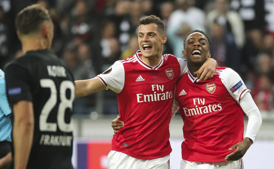 epa07853910 Arsenal&#039;s Joe Willock (R) celebrates with teammates Granit Xhaka (L) after scoring the opening goal during the UEFA Europa League Group F match between Eintracht Frankfurt and Arsenal ...