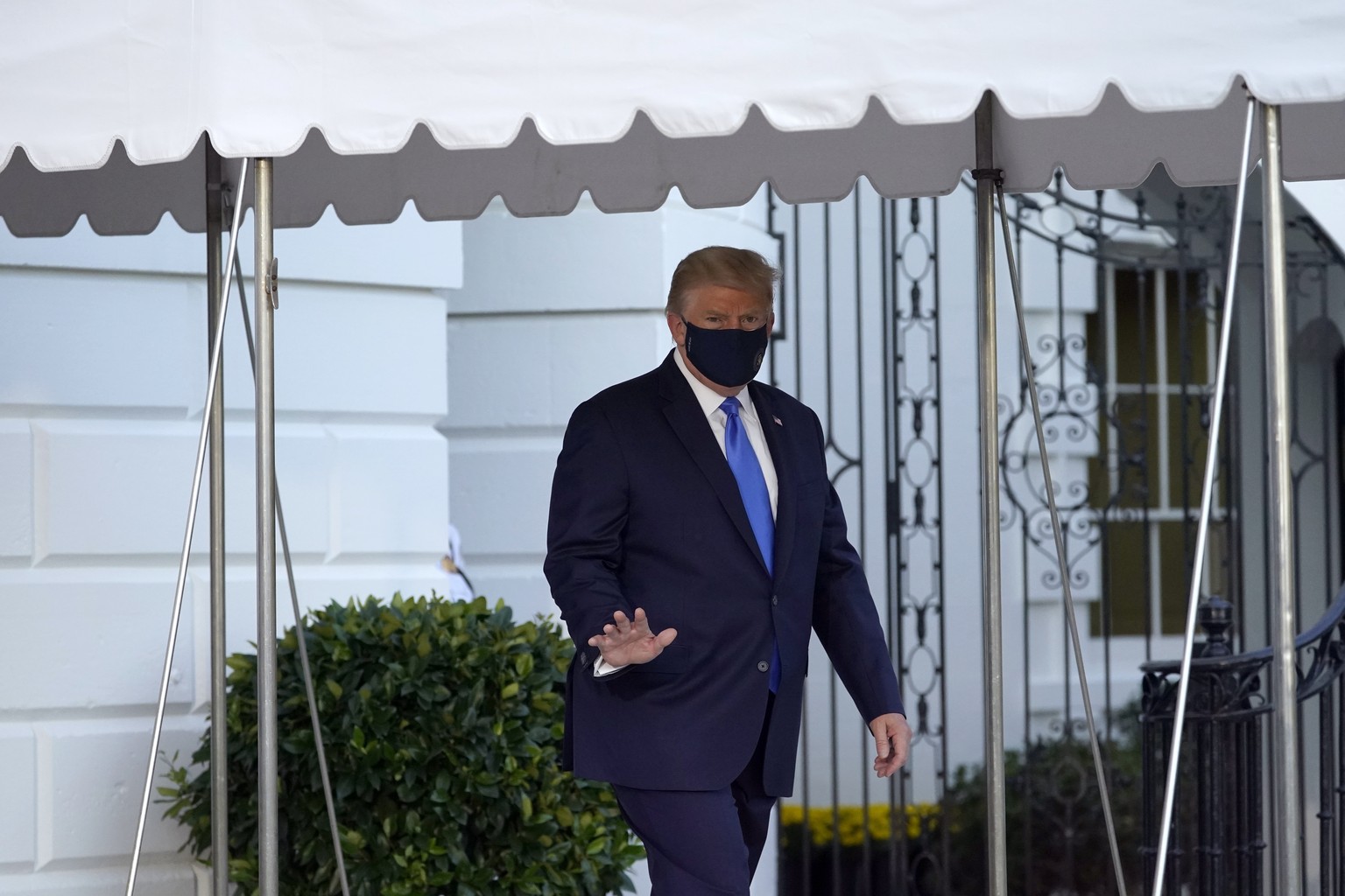 FILE - In this Oct. 2, 2020, file photo President Donald Trump waves to members of the media as he leaves the White House to go to Walter Reed National Military Medical Center after he tested positive ...
