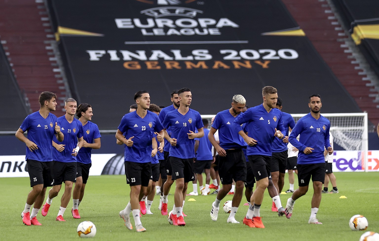 FC Basel&#039;s players jog during a training session in Gelsenkirchen, Germany, Monday, Aug. 10, 2020. FC Basel will play Shakhtar Donetsk in a Europa League quarterfinal soccer match on Tuesday. (La ...