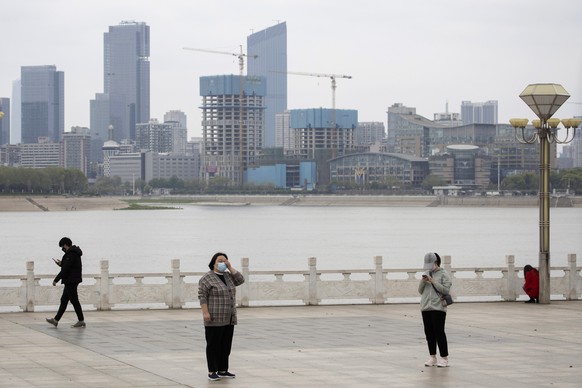 Residents observe social distancing at a park along the Yangtze River in Wuhan in central China&#039;s Wuhan province on Wednesday, April 1, 2020. Skepticism about ChinaÄôs reported coronavirus cases ...