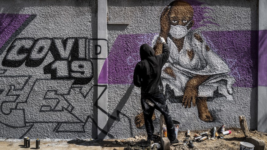 A member of the Senegalese graffiti collective &quot;RBS CREW&quot; paints informational murals advising how to stop the spread of the new coronavirus, on the wall of a high school in the Parcelles As ...