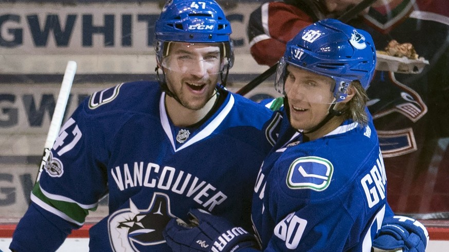 Vancouver Canucks left wing Sven Baertschi (47) celebrates his goal against the New York Islanders with teammate Markus Granlund (60) during the second period of an NHL hockey game Thursday, March 9,  ...