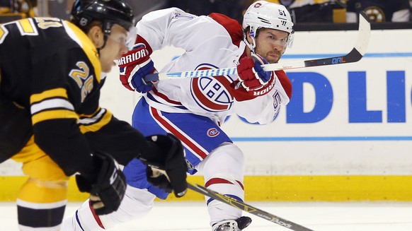 FILE - In this Oct. 22, 2016, file photo, Montreal Canadiens&#039; David Desharnais follows through on a shot during the first period of an NHL hockey game against the Boston Bruins, in Boston. The Ne ...