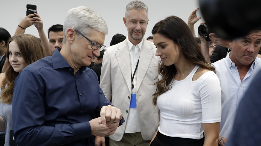 Apple CEO Tim Cook, left and soccer player Alex Morgan discuss the new Apple Watch 4 at the Steve Jobs Theater during an event to announce new products Wednesday, Sept. 12, 2018, in Cupertino, Calif.  ...