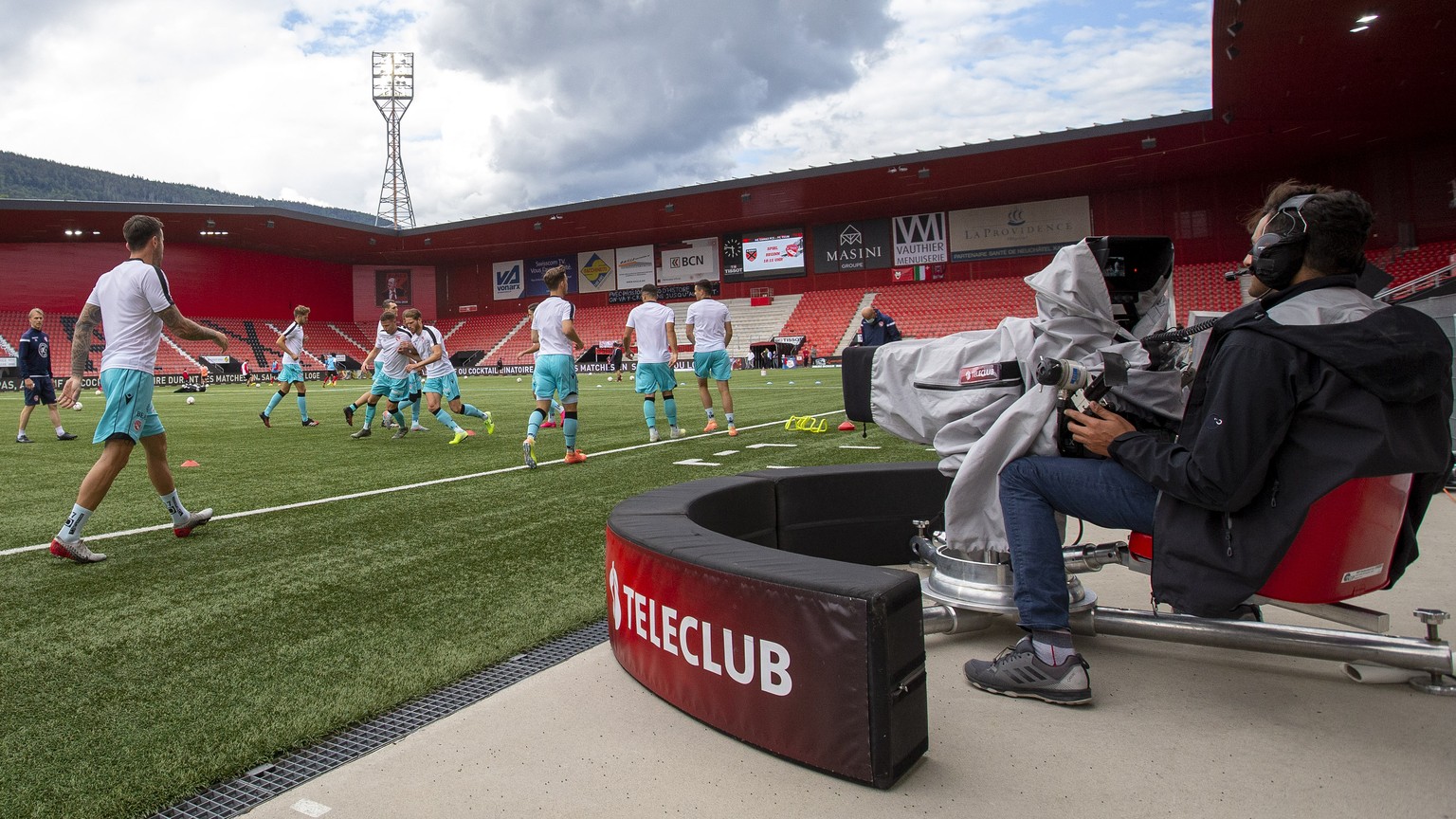 Xamax&#039;s players warm up near a camera of Teleclub broadcaster, prior the Super League soccer match of Swiss Championship between Neuchatel Xamax FCS and FC Thun, behind closed doors at the Stade  ...